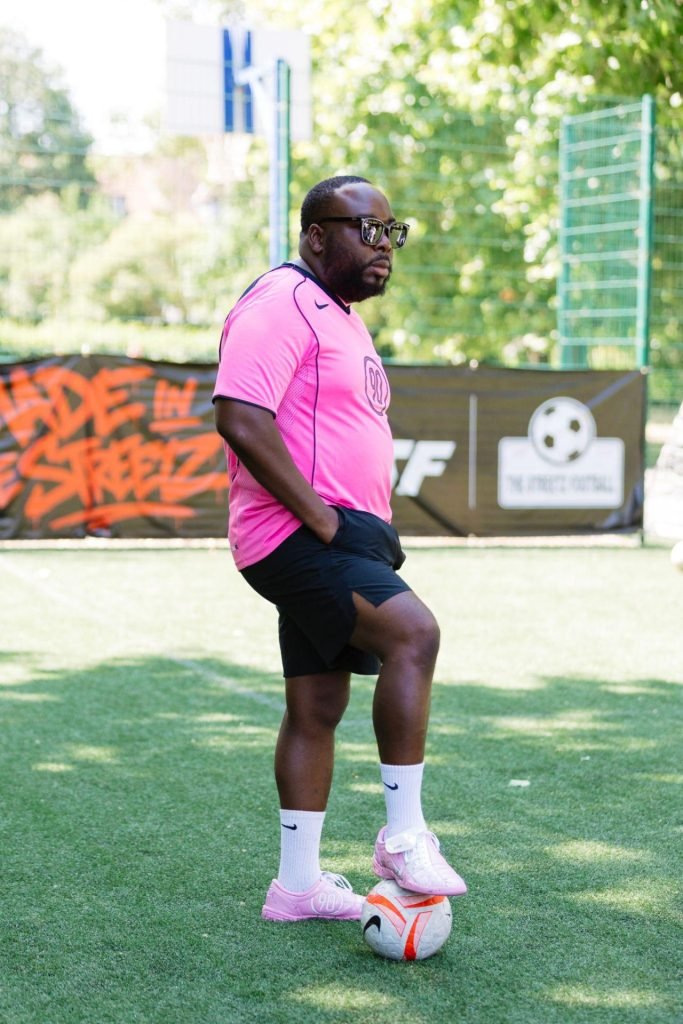 David Marriott in a pink TSF kit with his foot on a football at an urban pitch