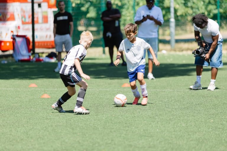 Young players dribbling through cones at a TSF session